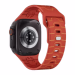 Bracelet Apple Watch EzStrap en silicone rouge au motif armure stylisée, présenté en gros plan sur une montre noire.