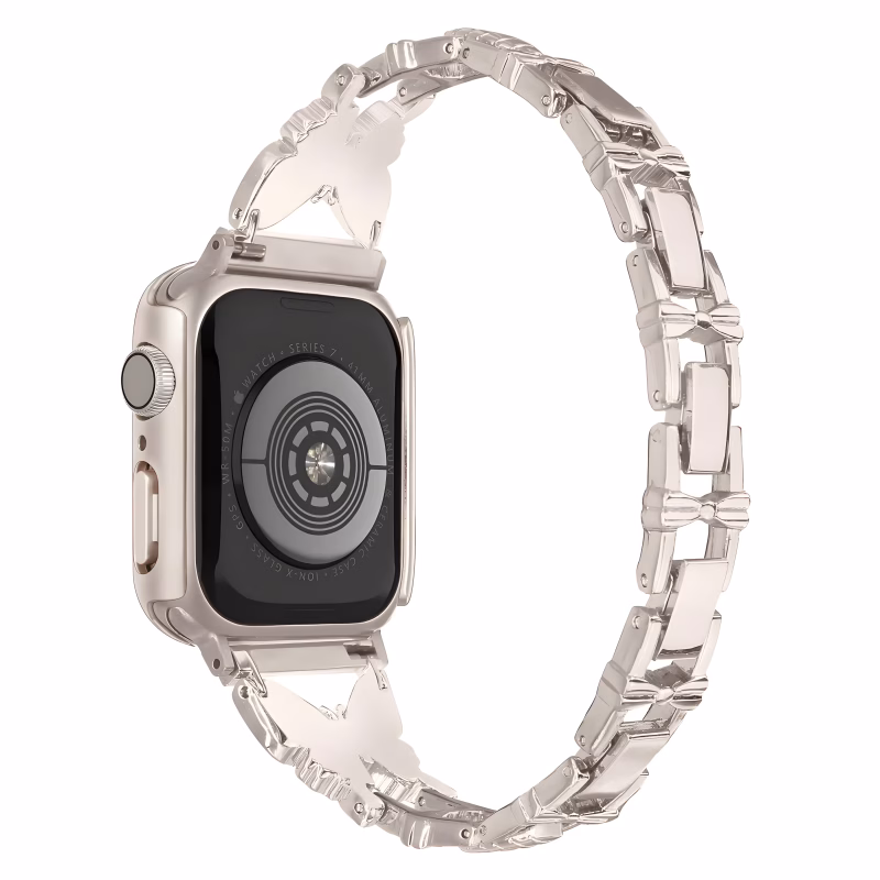 Bracelet Apple Watch EzStrap en acier inoxydable brillant avec design papillon et maillons ornementés, présenté en gros plan sur fond blanc.