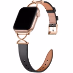 Bracelet Apple Watch EzStrap en cuir grainé noir avec fixation en métal doré en forme de X, style luxe, présenté en gros plan sur fond blanc.