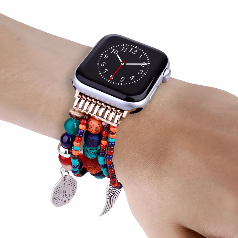 Bracelet Apple Watch EzStrap artisanal en métal, orné de pierres colorées et de perles texturées multirangs, porté au poignet d’une personne.