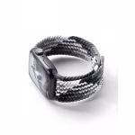 Bracelet Apple Watch EzStrap en nylon tressé à dominante noire, grise et blanche, de style sport texturé, présenté en gros plan posé sur une surface blanche.