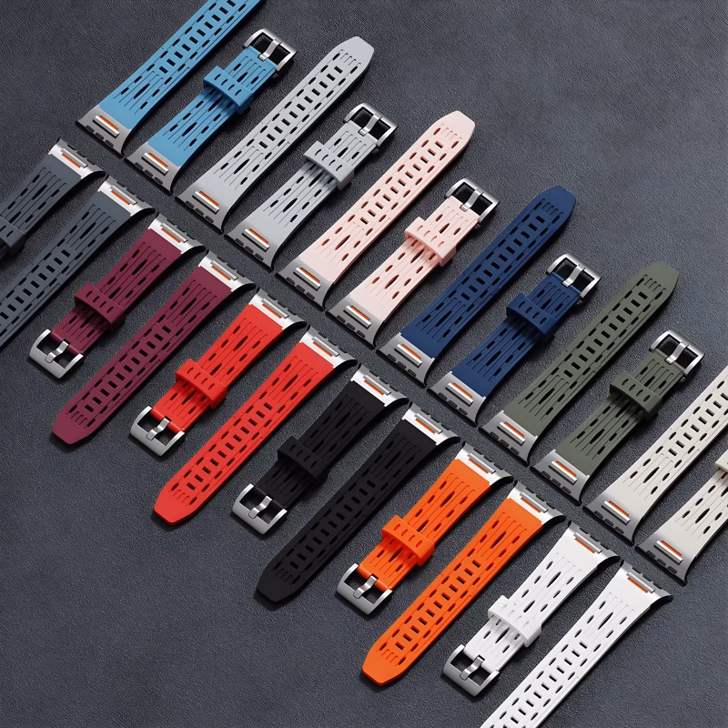 Bracelets Apple Watch EzStrap en silicone perforé de style sport, présentés en plusieurs coloris vifs et neutres, alignés sur une surface texturée gris foncé.